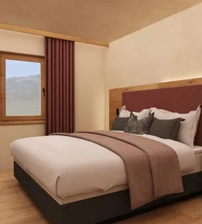 Gemütliches Hotelzimmer mit Doppelbett, Holzmöbeln und Bergblick