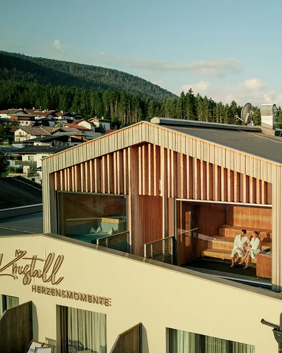 Mountain hotel with rooftop sauna and pool overlooking forest and alpine village